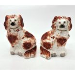 A pair of Victorian Staffordshire red and white spaniel ornaments (Dimensions: Height 33cm.)(