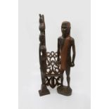 Two African carved figures, height 65cm diminishing, and a wooden rack (3).