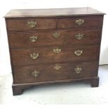 A George III oak chest of drawers, with two short and three long drawers, on bracket feet. (