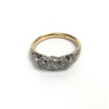 A 14ct gold and platinum three stone diamond ring.