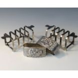 A pair of small silver Art Deco toast racks together with a pair of decorative continental silver