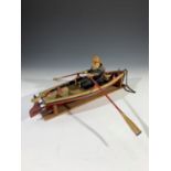 A carved wood model of a fisherman and boat 'White Wings', both by the Suffolk wheelwright Herbert