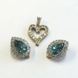 A pair of 9ct gold pear shaped blue stone clip on earrings each banded with small diamonds, together