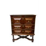 A 17th century oak chest on stand, with three long drawers on bobbin turned supports and bun feet,