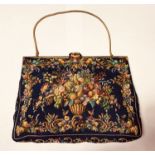 Very fine evening purse of dark blue tapestry style fabric with enamelled gilt metal frame and