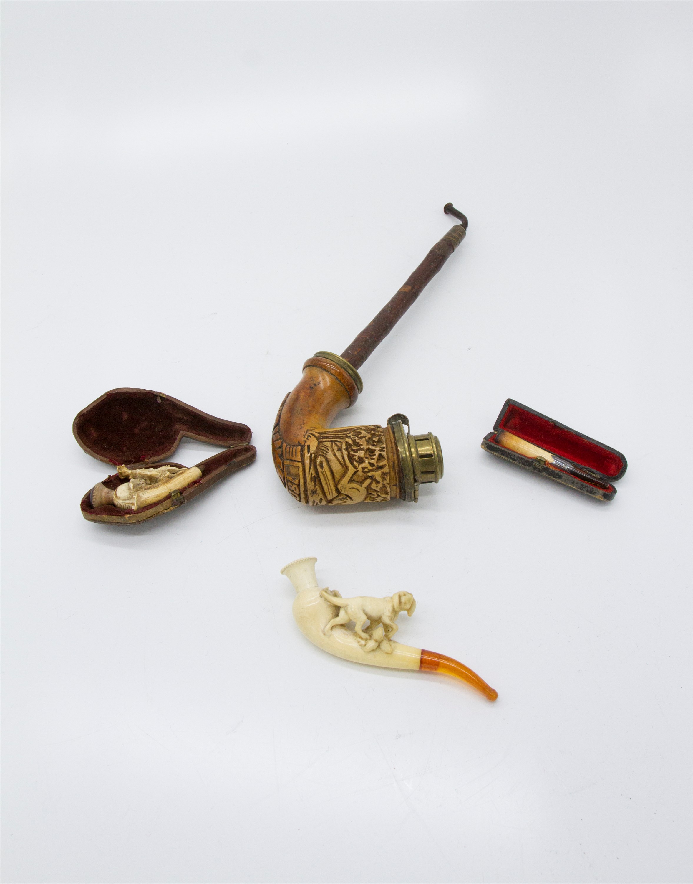 Meerschaum pipes including one mounted with a horse (cased), another mounted by a Setter type dog, a