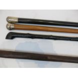 Two Victorian silver topped wooden walking canes, an African paddle and another walking cane (4).