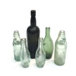 A collection of vintage bottles comprising; a black wine bottle - W & A Gilbevl, a green Perrier