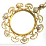 A boxed gold and pearl circle pendant with chain.