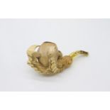 A Meerschaum pipe with amber stem, the bowl depicting a bird of prey's claw clutching an egg,