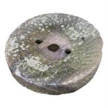 A granite mill stone. (Dimensions: Diameter 71cm.)(Diameter 71cm.)