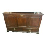 A George III oak mule chest, the triple panelled front above two drawers on bracket feet, height