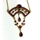 An Art Nouveau gold red stone set necklace.