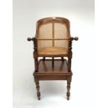 A Victorian mahogany bergere childs high chair on stand, with rattan back and seat on turned