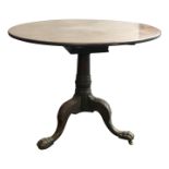A George III mahogany tripod table, the circular top on a turned stem and acanthus leaf carved