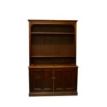 A mahogany bookcase, late 19th century, the open top with three shelves, the lower part with a