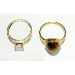 Two gold rings, one set with tigers eye.