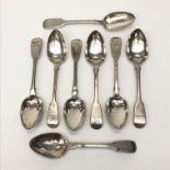 A set of six George IV silver fiddle pattern dessert spoons each engraved with a spread winged