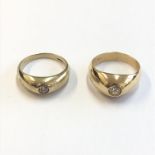 Two gold rings each with a collet set stone.