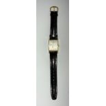 A Longines gentlemans wristwatch with rectangular white dial, inscribed K & E 14K to back of case,