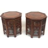 A pair of Indian carved wood folding occasional tables, circa 1900, each with brass inlaid octagonal
