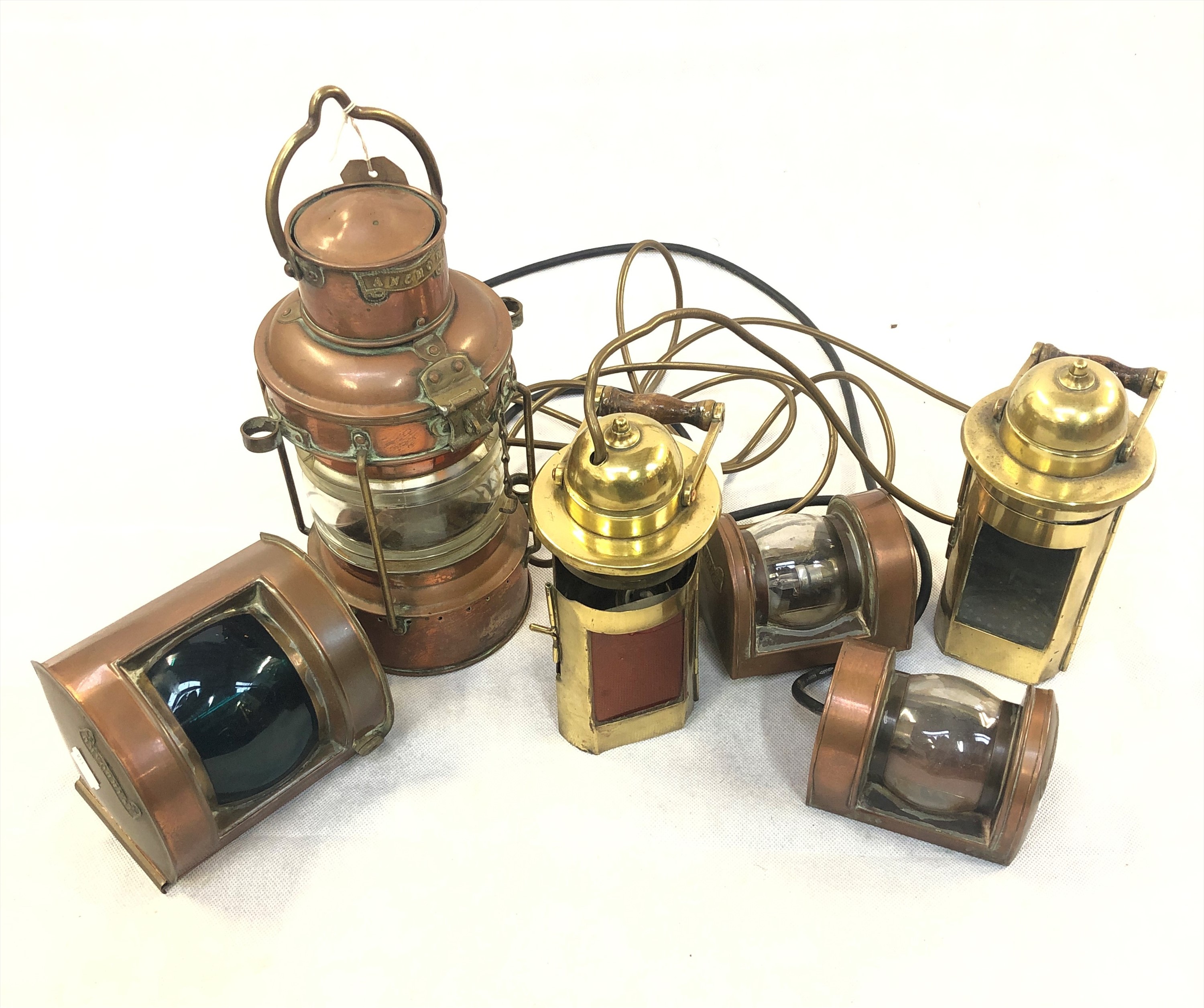 A ship's copper anchor lamp, height 34cm, together with five other assorted maritime lamps. The pair