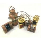 A ship's copper anchor lamp, height 34cm, together with five other assorted maritime lamps. The pair
