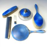 A silver dressing table set with blue guilloché enamel.