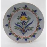 A Bristol delft plate, circa 1730, with floral decoration. (Dimensions: 20.5cm diameter.)(20.5cm