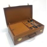 A gentleman's leather dressing suitcase, with fitted interior and contents of hallmarked silver