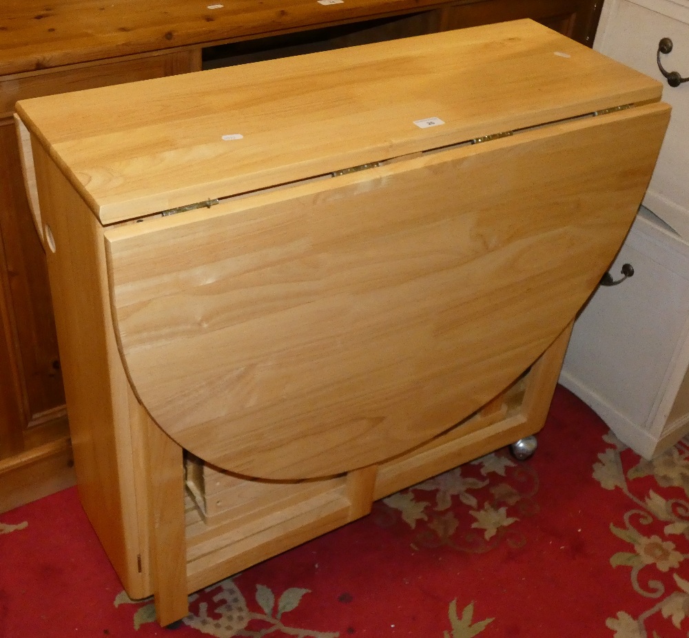 A modern drop leaf dining table incorporating integrated set of four chairs