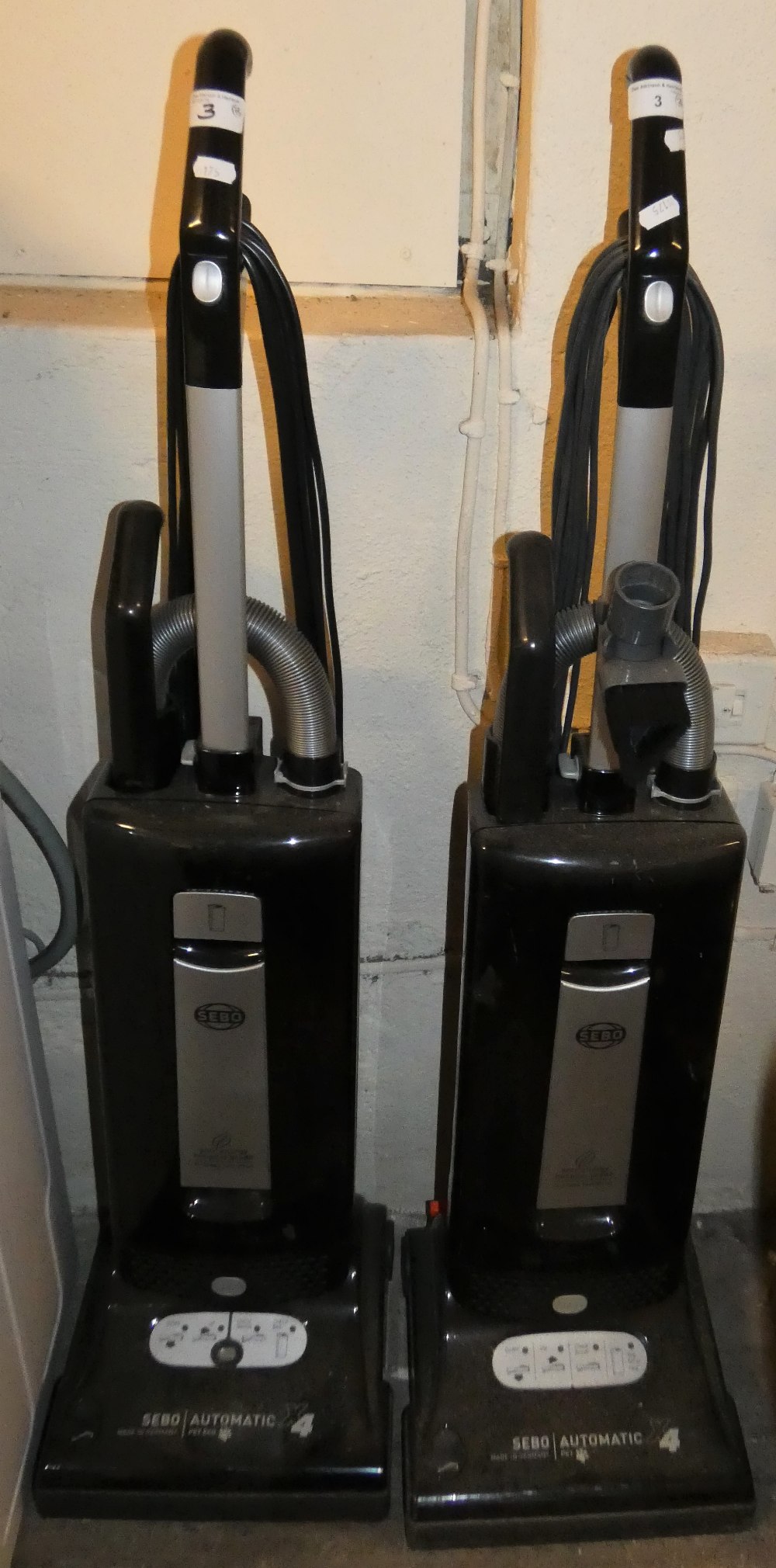 A pair of Sebo upright vacuum cleaners x/series