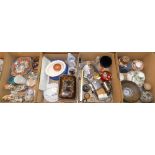 Four boxes of miscellaneous items including car badges, Linda Forrest centre piece, paperweights,