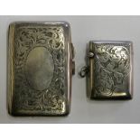 A silver arched cheroot case, Birmingham 1919 with floral decoration and a similar vesta case