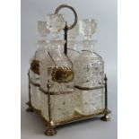 A Walker & Hall four bottle electroplated decanter stand, with central carry handle, containing