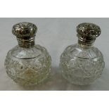 A Victorian pair of silver and cut glass scent bottles, Birmingham 1900, the hob nail body with