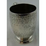 A Victorian silver christening mug, London 1874, of barrel form with engraved floral decoration,