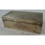 A silver presentation cigarette box, the engine turned lid to plain sides, the front with an