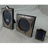 A silver photograph frame, London 1988, with an embossed heart shape border, height 20 cm,