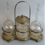 An Edwardian electroplate decanter stand, with bead border, ram's head masks between, raised on four