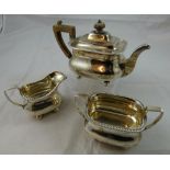 A Victorian silver three piece tea service, London 1895, of baluster form with a gadrooned border,