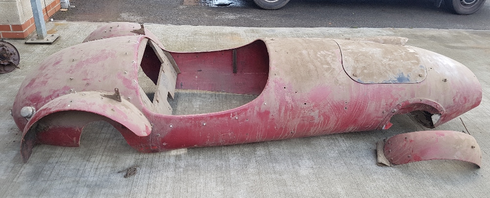 A Moss Monaco fibreglass body tub, with front wings and some wooden panels, formerly registered as