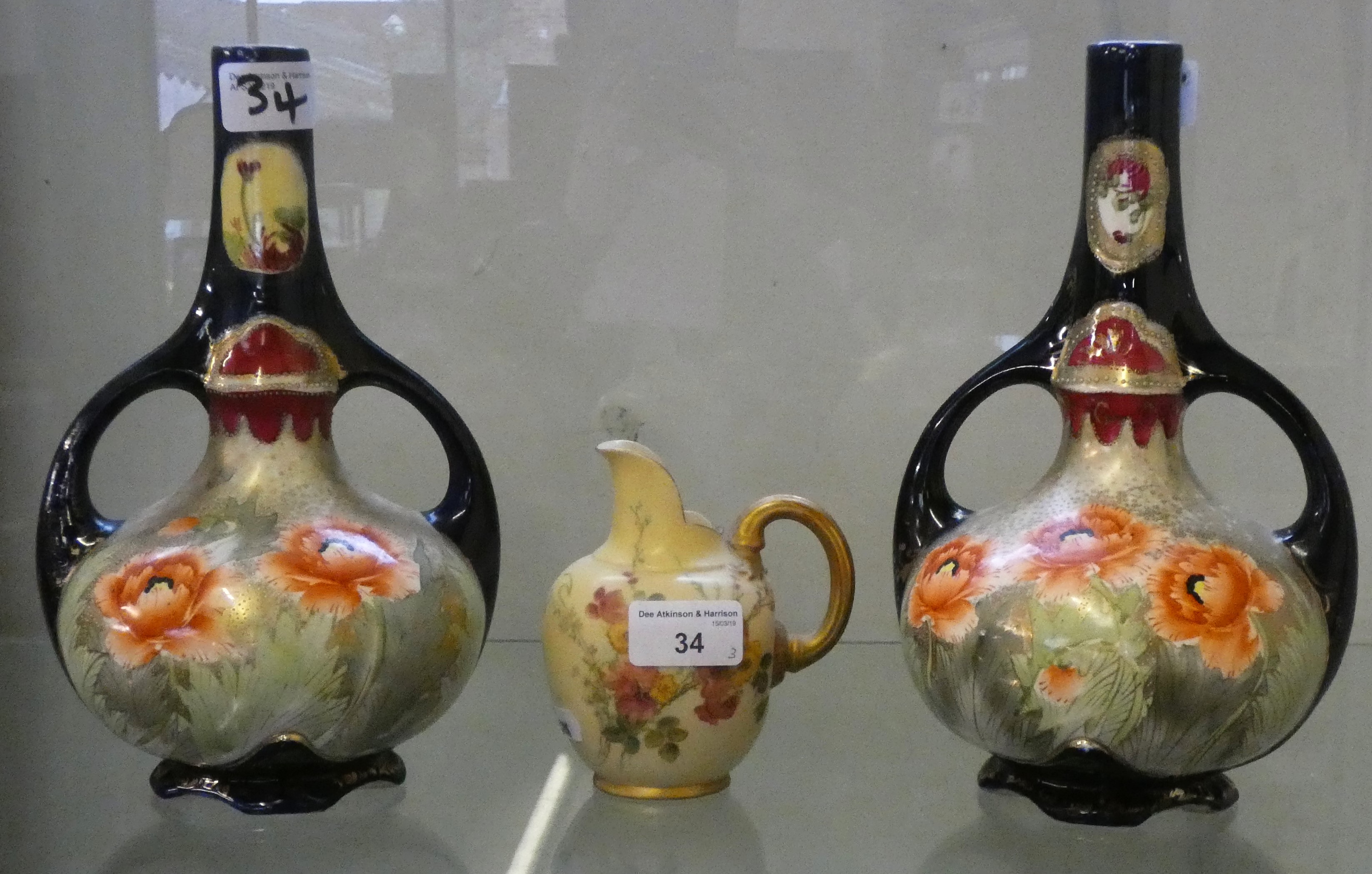 A Royal Worcester jug together with a near pair of Royal Nippon twin handled vases (3)