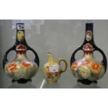 A Royal Worcester jug together with a near pair of Royal Nippon twin handled vases (3)