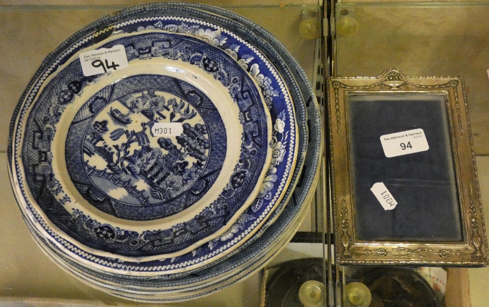 Nine blue and white plates together with silver photo frame