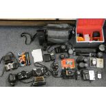 A collection of cameras together with a camera bag with Olympus camera and various lenses together