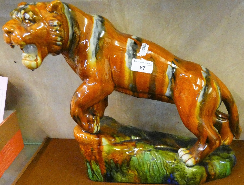 A ceramic model of a tiger, 34 cm high x 50 cm long