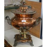 Bell, Nottingham - a 19th century copper samovar with twin handles and tap standing on a scroll