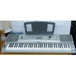 A Yamaha electric keyboard with stand
