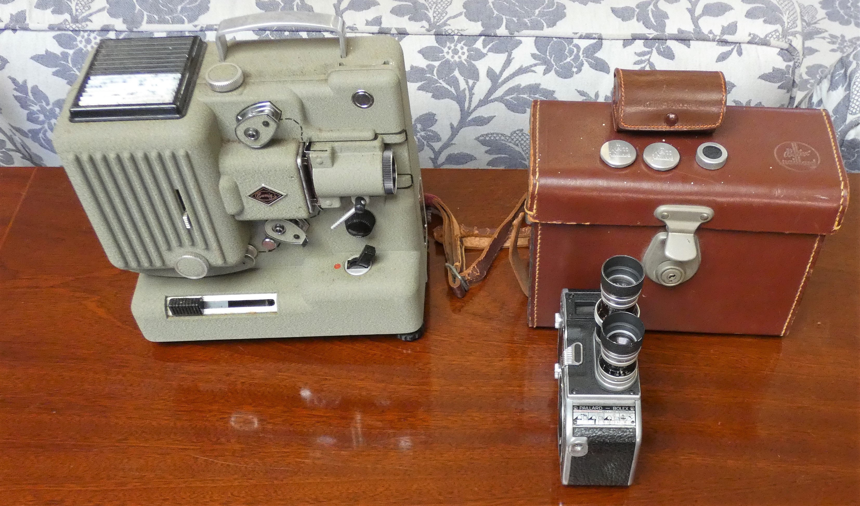 An Eumig P8 projector and a Paillard Bolex B8 cine camera and case